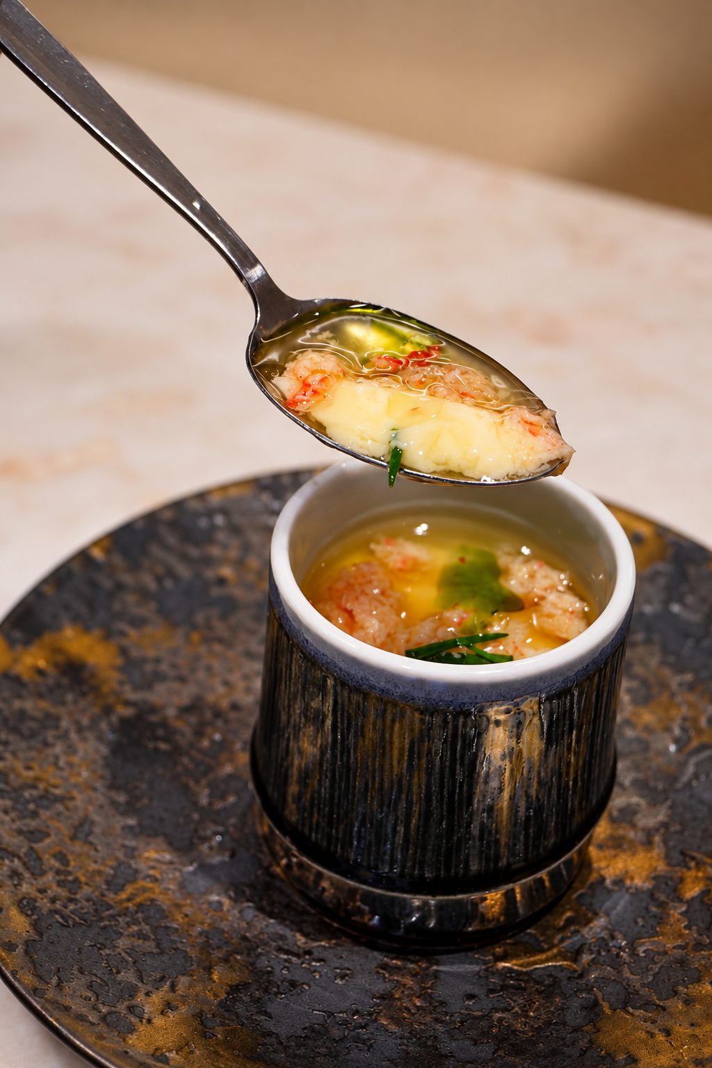 Snow crab chawanmushi lifted on a spoon