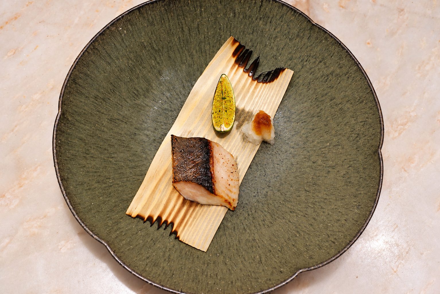 Grilled cod on a cedar sheet