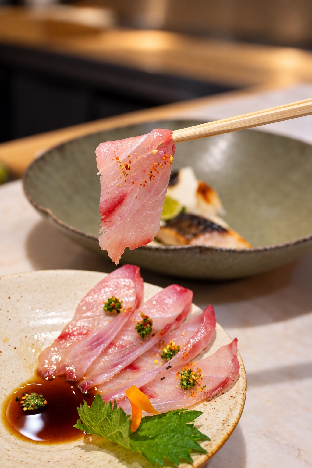 Shima aji usuzukuri with chopsticks